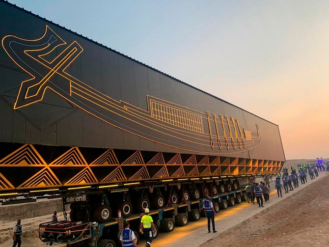 A smart vehicle transports Pharaoh Khufu’s boat, which dates back some 4,600 years, early Saturday, Aug. 7, 2021 from the Giza Pyramids to the soon-to-complete Grand Egyptian Museum. (AP Photo)
