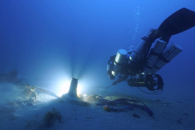 Diver with ancient ram discovery, Sicily, Italy. Photo by Mario Arena