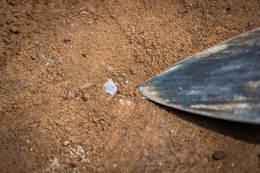 Independent researcher Thomas Talbot finds a flake of manufacturing debris, untouched for 13,000 years, at the Belson Clovis Site in St. Joseph County. Photo: Michigan Photography