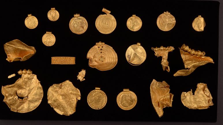 A 1,500-Year-Old Treasure Trove Full of Jewelry, Medals, and Gold Coins Unearthed by an Amateur Metal Detectorist on the Jutland Peninsula of Denmark.