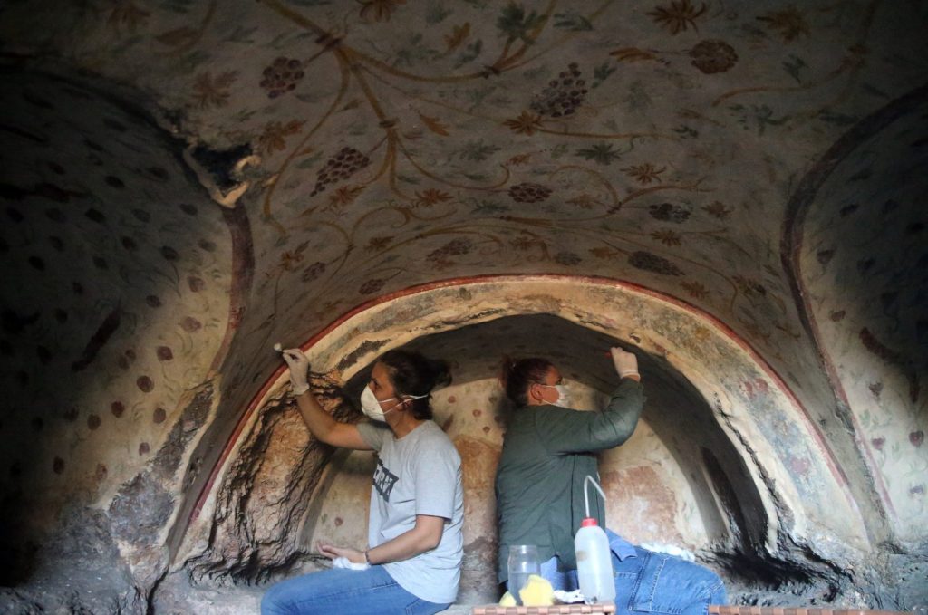 Two archaeologists work on the wall motifs of a room inside a rock tomb in the ancient city of Blaundus, Uşak, western Turkey. (AA Photo)