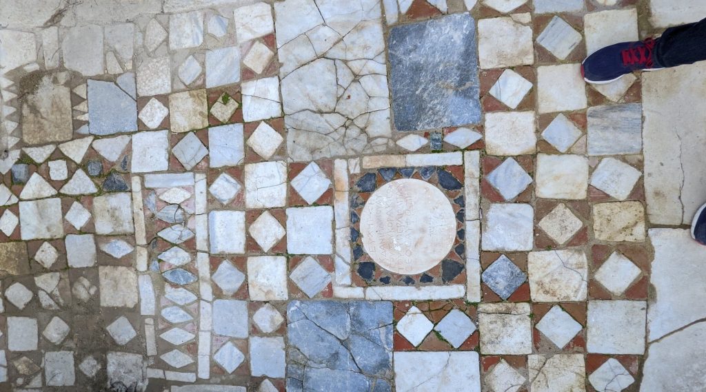 The floor of the synagogue in Side, Turkey, features a plaque with Greek and Hebrew inscriptions