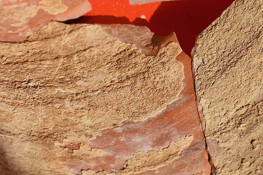 Detail of the interior of the chamber pot, showing lime-scale concretions within it. Photo: R. J. A. Wilson.