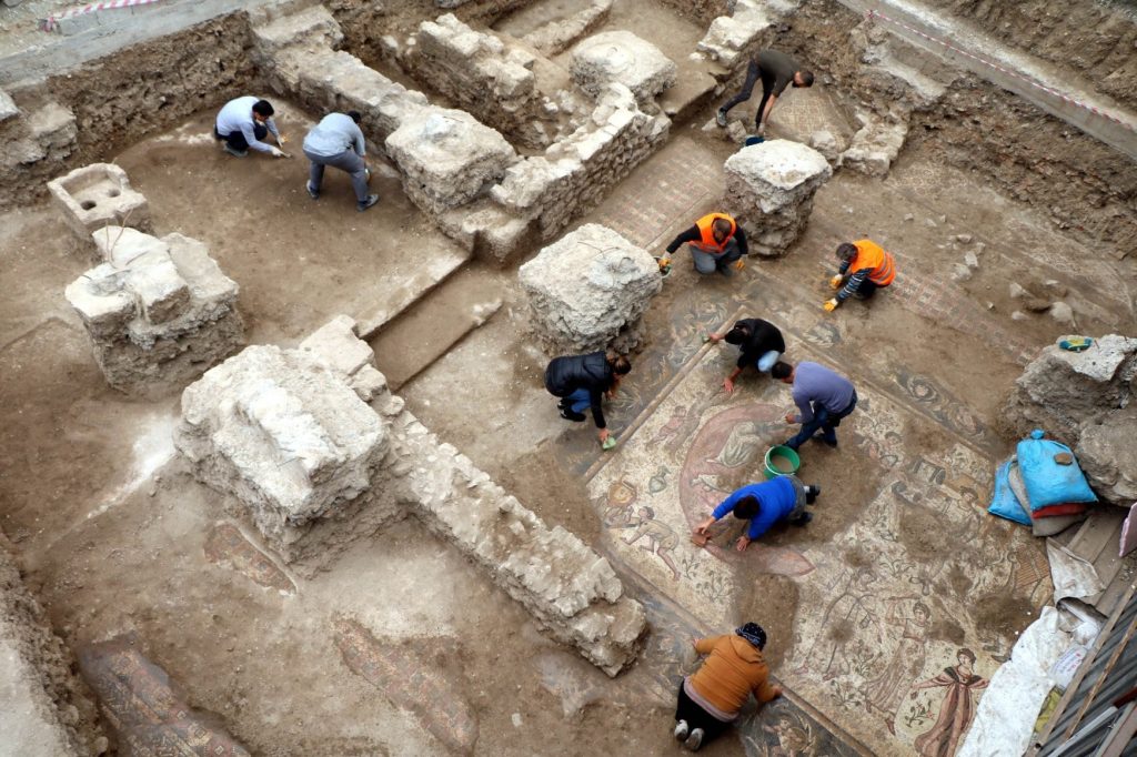 Several archeologists work to carefully unearth the mosaics found at the ancient city of Germanicia, Turkey.