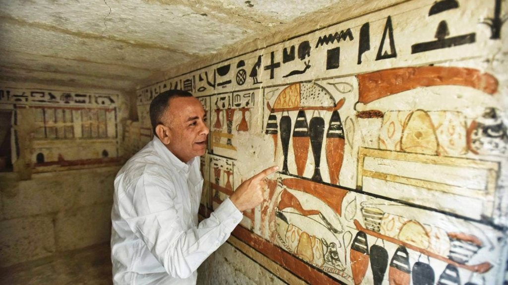 Mostafa Waziri, Secretary General of the Supreme Council of Antiquities, views hieroglyphics inside a recently discovered tomb near the famed Step Pyramid, in Saqqara, south of Cairo, Egypt.