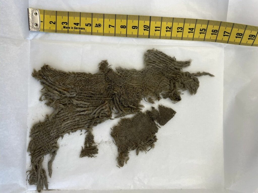Remains of textiles found at the Horse Ice Patch. Perhaps something like this was worn inside the shoe? (Photo: Espen Finstad/Secrets of the Ice)