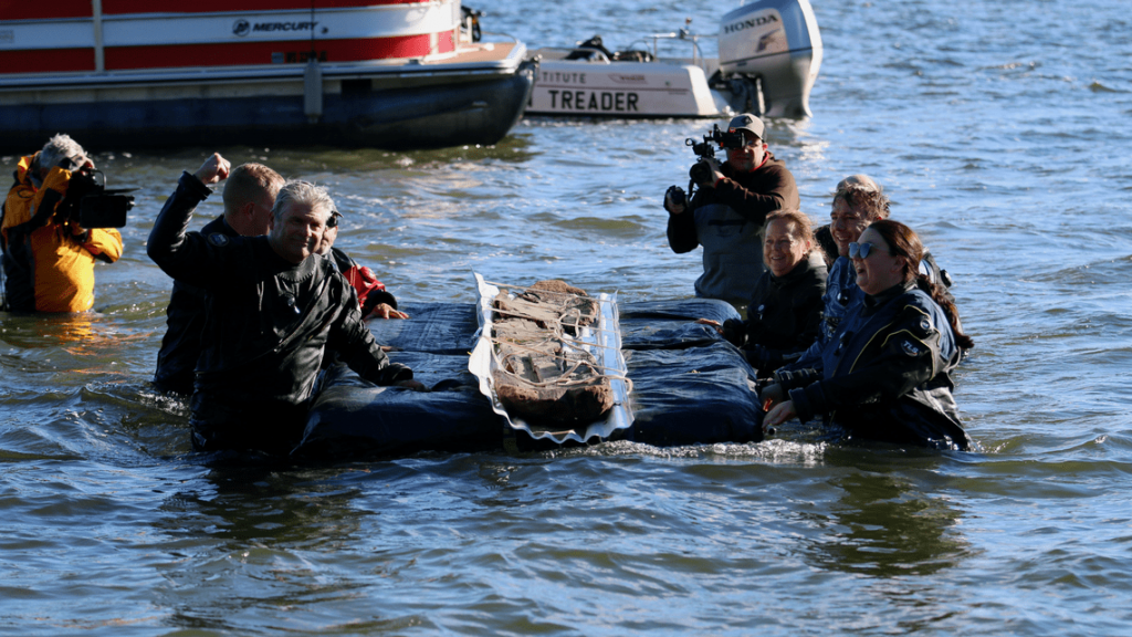 Divers recover a 3,000-year-old dugout canoe Thursday, September 22, 2022 from Lake Mendota in Madison, Wis. Photo from the Wisconsin Historical Society.