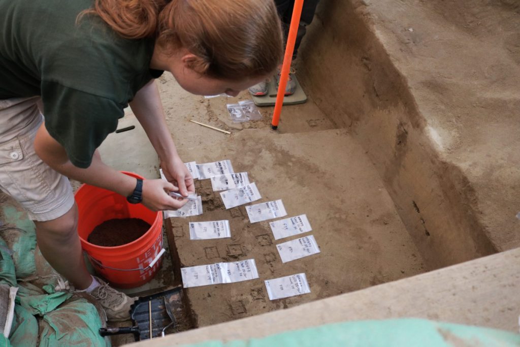 Excavator at work recording artifacts excavated from a pit feature at the Cooper’s Ferry site.. Photo: Loren Davis