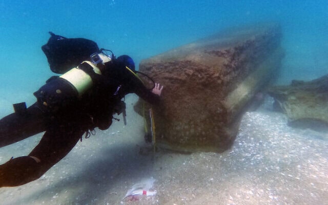 An Israel Antiquities Authority archaeologist checks out pieces of 1,800-year-old marble from a shipwreck off the shore of Beit Yanai in central Israel. Photo: Israel Antiquities Authority's Theft Prevention Unit