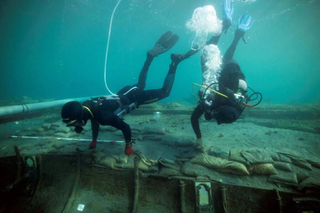 Divers from the University of Valencia map and assess the condition of a 2,500-year-old Phoenician vessel submerged 60 meters off the beach in Mazarrón, Spain, on June 20, 2023. Photo: Jose A Moya/Murcia Regional Government