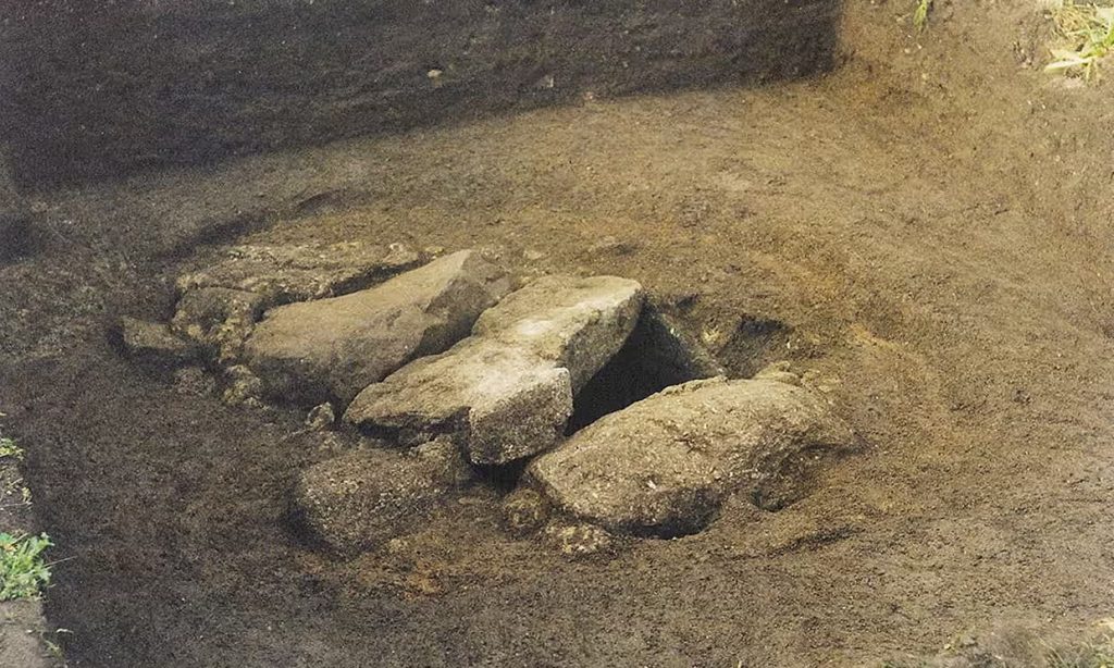 Capstones at the Bryher burial site, which was discovered in 1999. Photo: Isles of Scilly Museum Association