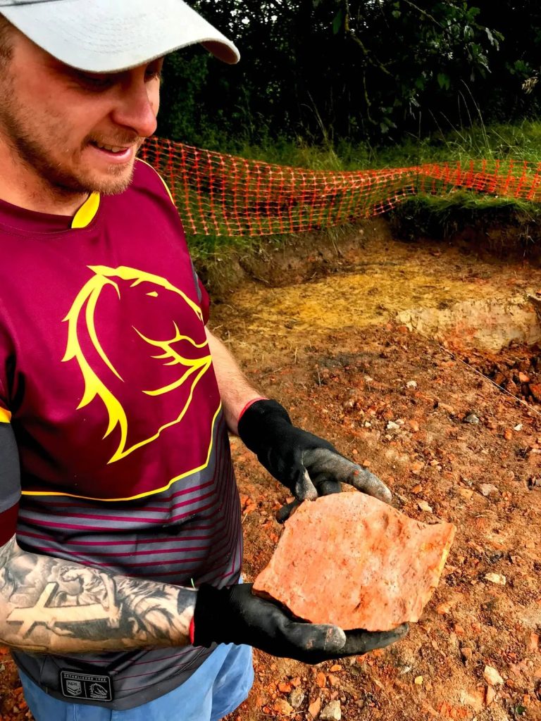 Tile with paw prints found by volunteers Josh.