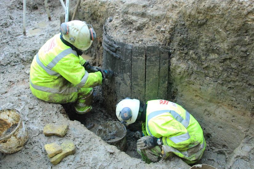 Archaeologists excavate one of the medieval timber wells. Image: ©MOLA