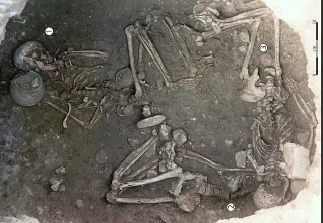 View taken from the upper part of the 255 storage pit showing the three skeletons, with one individual in a central position (Woman 256 1) and the other two placed under the overhang of the wall (Woman 2 and Woman 3) Image Credit: Ludes et al., Sci. Adv. 10, eadl3374