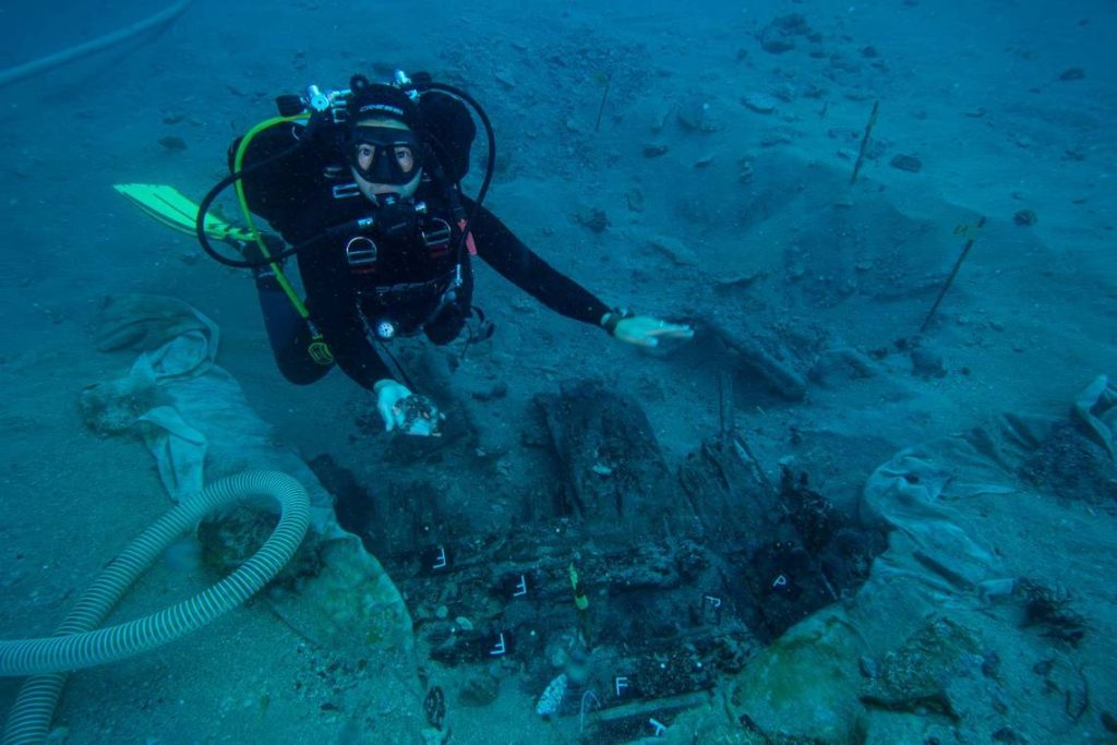 An archaeologist holds a fragment of a 400-year-old trumpet found at the wreck. Photo: International Center for Underwater Archaeology in Zadar