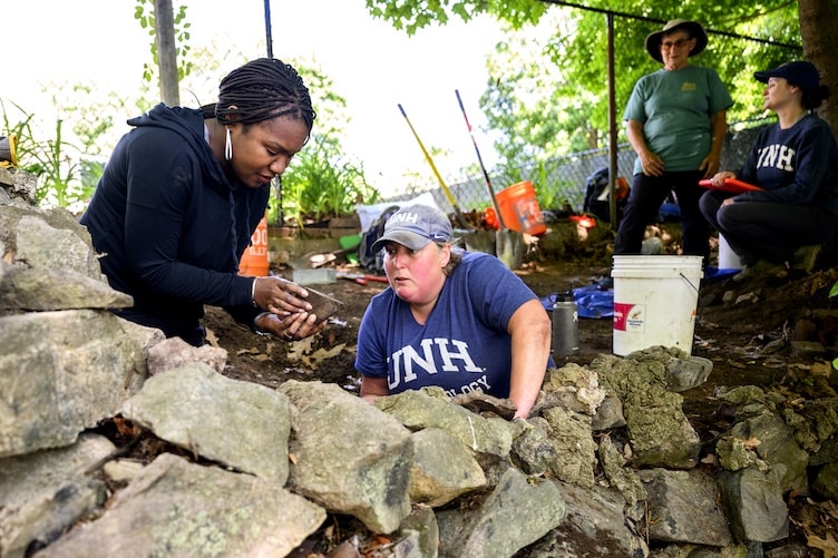 Left to right, Kabria Baumgartner, Northeastern University historian, and Meghan Howey, University of New Hampshire archaeologist, at the dig site of what archaeologists believe is the home of King Pompey. Photo: Matthew Modoono/Northeastern University.