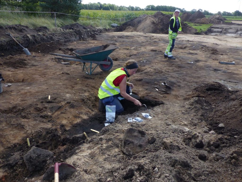 Petra Nordin examines one of the graves, grave 20. Photo: Archaeologerna 