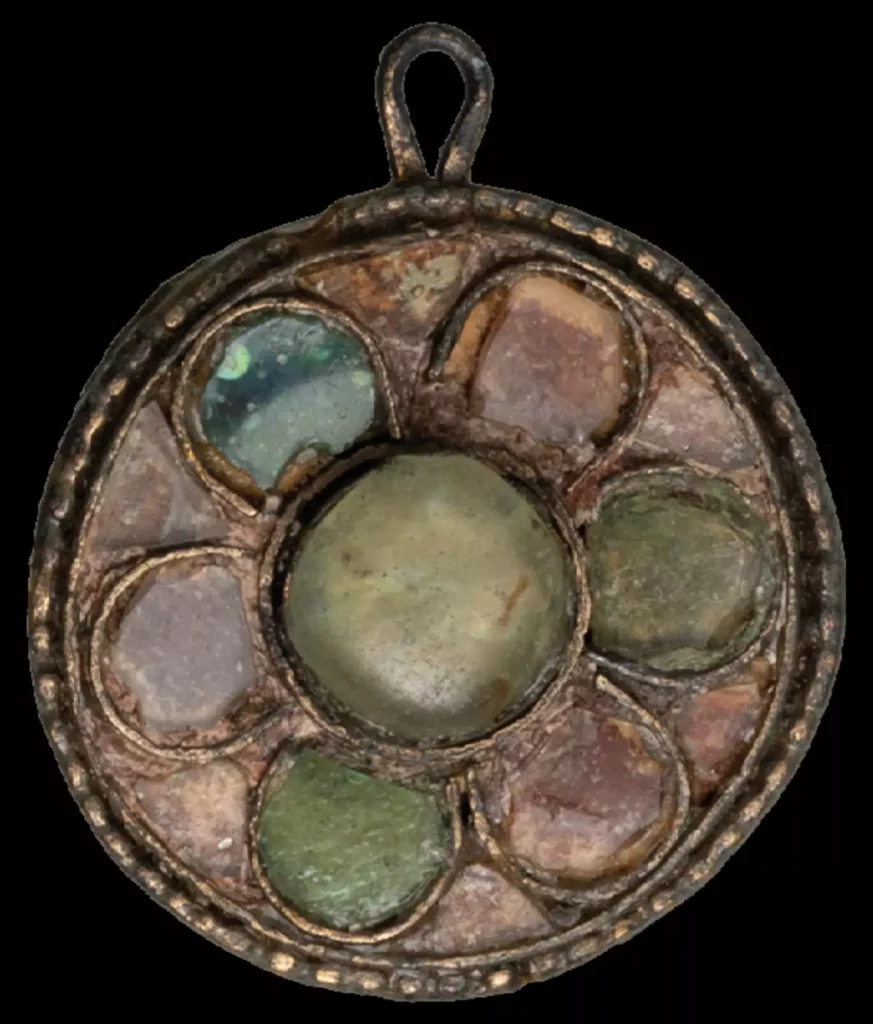 Coat clasp with glass inlay - an Avar-period artefact that is typically associated with higher social status of women as well as higher biological connectivity as revealed by ancient DNA. Credit: Benedict Seidl