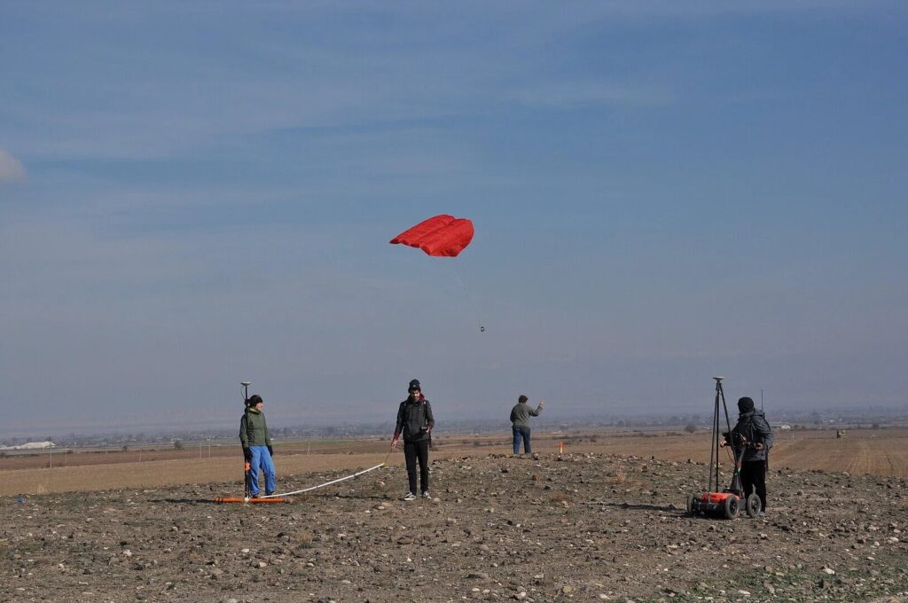 The researchers document and investigate a kurgan with a ground penetrating radar (right), an electromagnetic probe (left) and a camera attached to a kite. Credit: Wolfgang Rabbel