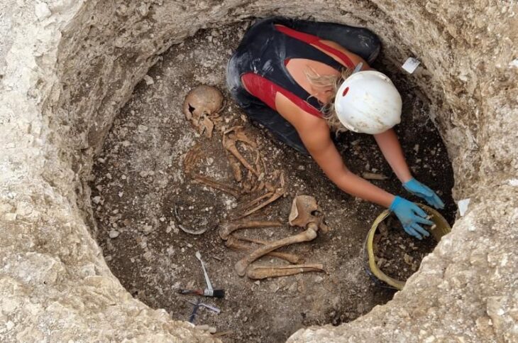 A female researcher, excavating a Late Iron Age Durotriges burial at Winterborne Kingston. Credit: Bournemouth University.