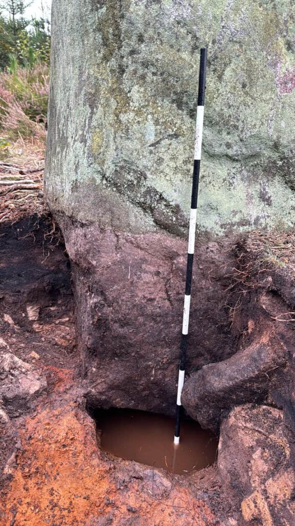 The stone sitting above a natural spring. Credit: Forestry England