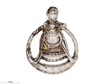 Pendant showing the only known Viking-Age depiction of a pregnant body. The artefact was found in a 10th century, Swedish burial for a woman, buried with a rich and varied artefacts assemblage as well as animals -- one interpretations is that she was a 'seeress'/ritual specialist. Credit: O. Myrin, The Swedish History Museum/SHM