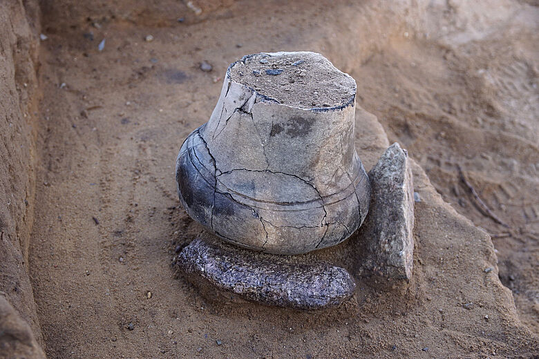 This very small, bottle-shaped urn likely contained a child. Cover Image Credit: Archaeological Museum Hamburg / BU