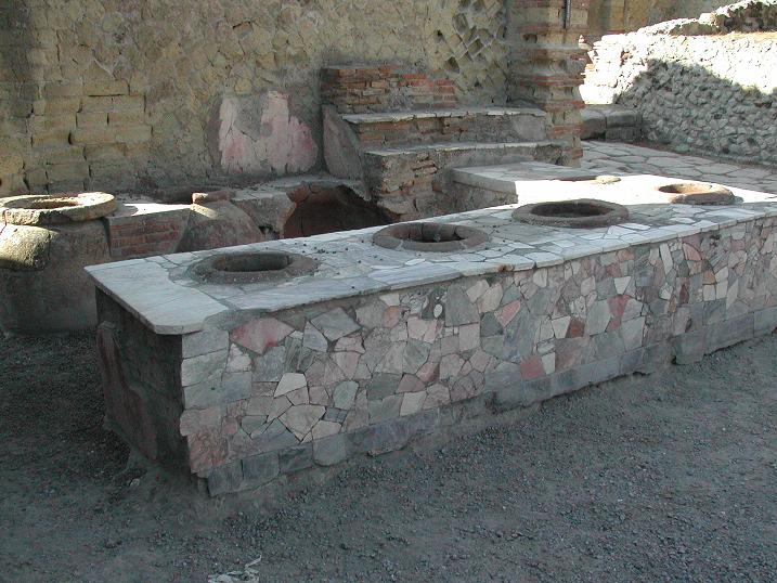The renowned thermopolium of Herculaneum, an ancient Roman street food shop where hot meals and drinks were served to the public. Credit: Aldo Ardetti, Wikimedia Commons