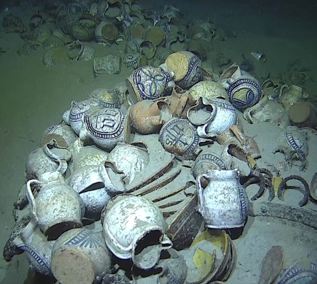 Camarat 4 remarkably preserved cargo includes around 200 multicolored faience jugs, many still embedded in sediment. Credit: Drassm - Marine Nationale