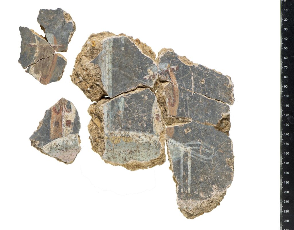 Reassembled wall plaster fragments featuring lyres—ancient stringed instruments—showcasing the musical themes of Roman interior decoration at the Liberty site. Credit: Museum of London Archaeology (Mola)