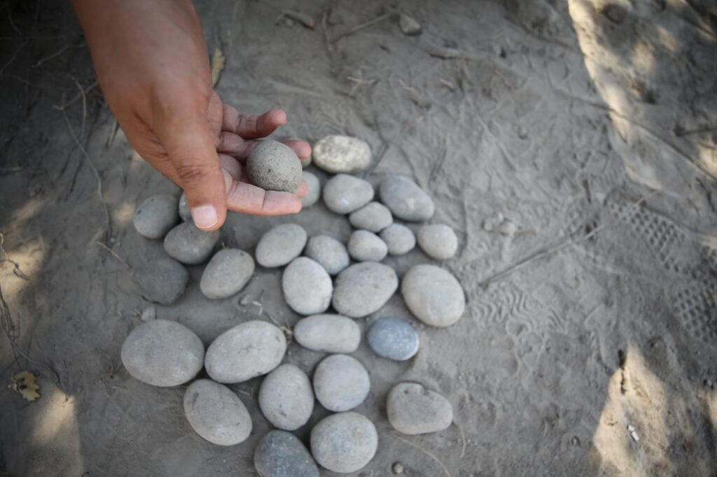 3,500-year-old sling stones unearthed in front of the palace structure during archaeological excavations at the ancient city of Troy in Çanakkale, Türkiye. Credit: AA