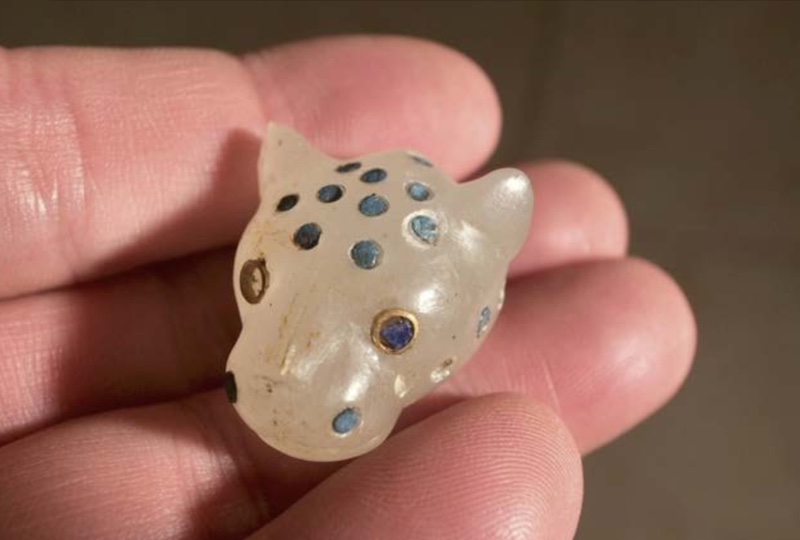 A finely crafted panther head made of white lapis lazuli, with inlaid eyes of gold and other precious materials — possibly used in ritual or ceremonial contexts. Credit: Japanese Institute of Anatolian Archaeology.