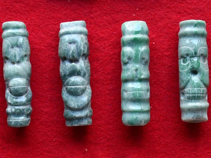Four jadeite tubular beads showing live and dead spider monkeys. Credit: University of Houston
