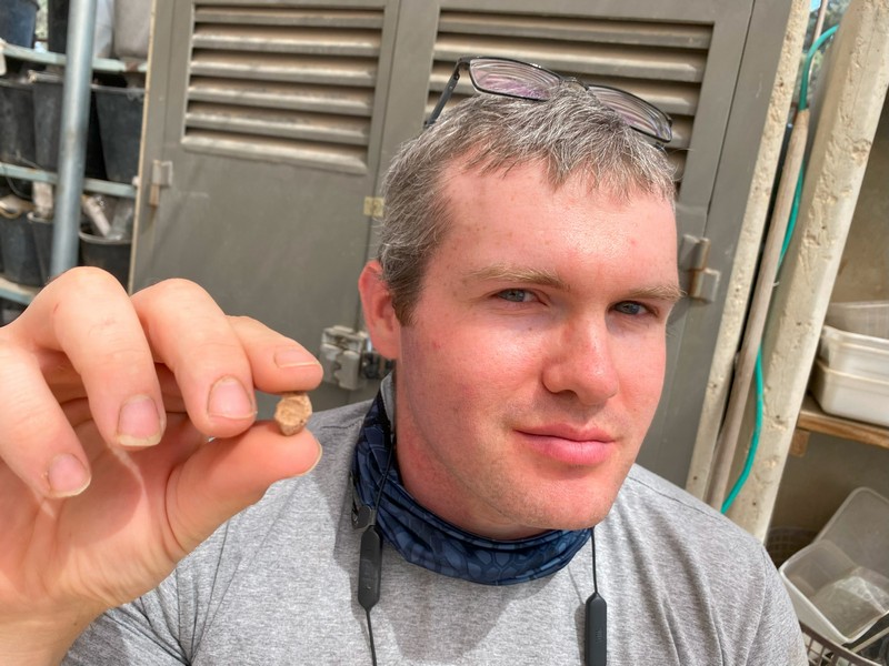 Archaeologist Mordechai Ehrlich holding the sealing. Credit: Temple Mount Sifting Project (TMSP)