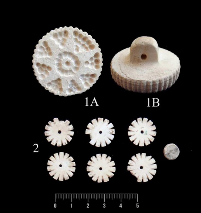 Limestone stamp seal and decorative beads of white marble from Grave 12. Credit: Vahdati et al. 2025