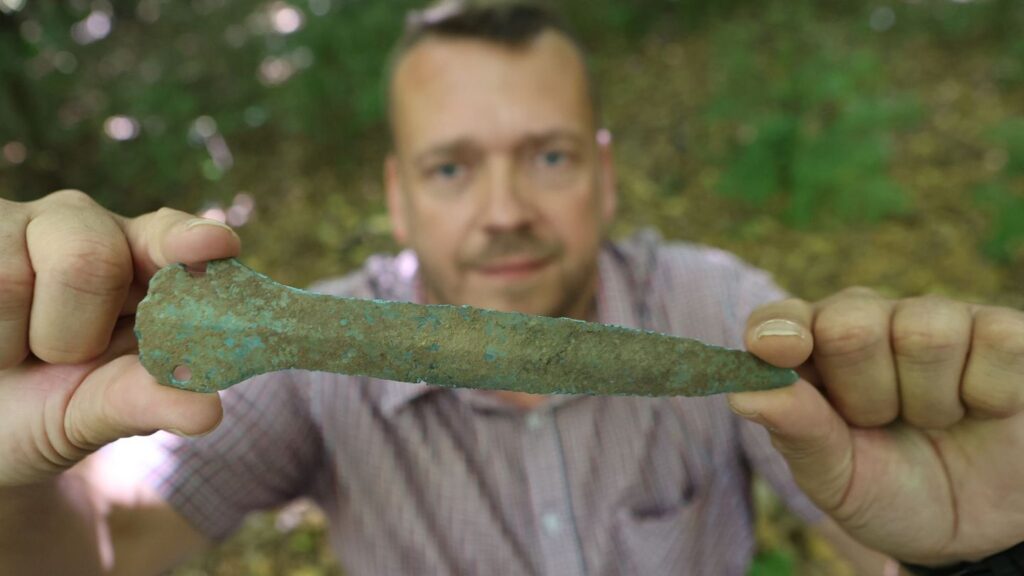 Maik Böhner discovered a Bronze Age dagger in the forest. Image Credit: Matthias Bein/dpa