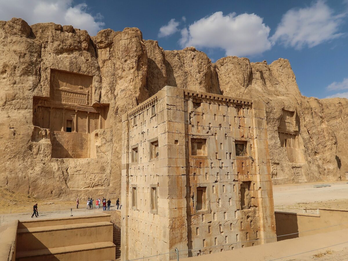 Naqsh-e Rustam necropolis in Iran, a view from South-West. Foreground: stone tower Ka'ba-ye Zartosht; background: left – tomb of king Darius II, right – tomb of Darius I (Darius the Great). Credit: Public Domain