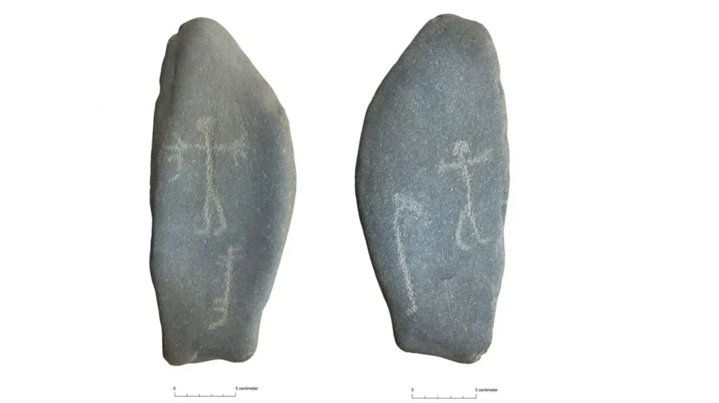 The 3,000-year-old carved stone, measuring 10 × 20 cm, with human, animal, and boat engravings on both sides. Credit: Hanne Bryn / NTNU University Museum