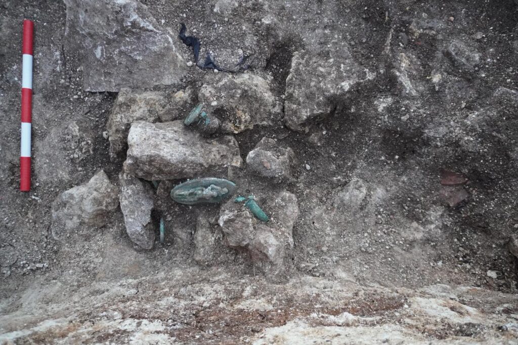 Above the horse’s head, archaeologists discovered bronze and gilded harness decorations featuring high-relief depictions of mythological figures. Credit: Община Тополовград - Topolovgrad Municipality