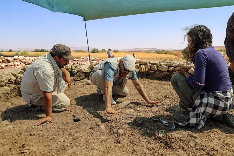 Archaeologists uncovered a 9,500-year-old public building with a vivid red-painted floor at Çayönü Tepesi. Credit: AA