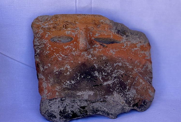 5,000-year-old pottery fragment from Gökhöyük, Türkiye, featuring detailed human facial features with almond-shaped eyes, arched eyebrows, and a prominent nose.