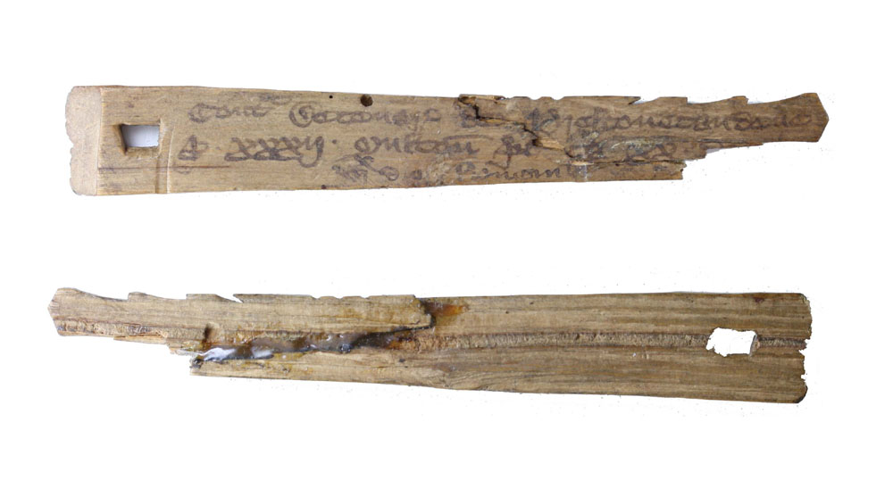 Medieval English split tally stick (front and back). The notches and inscriptions record a debt owed to the rural dean of Preston Candover, Hampshire: a tithe of 20 pence on 32 sheep, totaling £2 13s. 4d. Credit: Public Domain