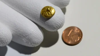 The 2,200-year-old Celtic gold coin — smaller than a one-cent piece — was presented in Dresden. Credit: Robert Michael / dpa.