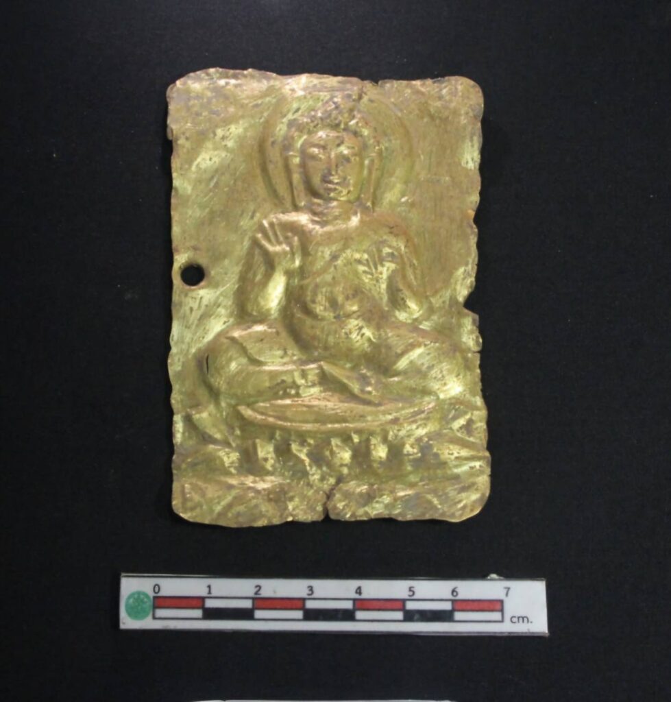 Rectangular gold sheet embossed with a seated Buddha image, in relatively good condition, measuring 8 cm wide and 12.5 cm high. Credit: Thailand’s Fine Arts Department