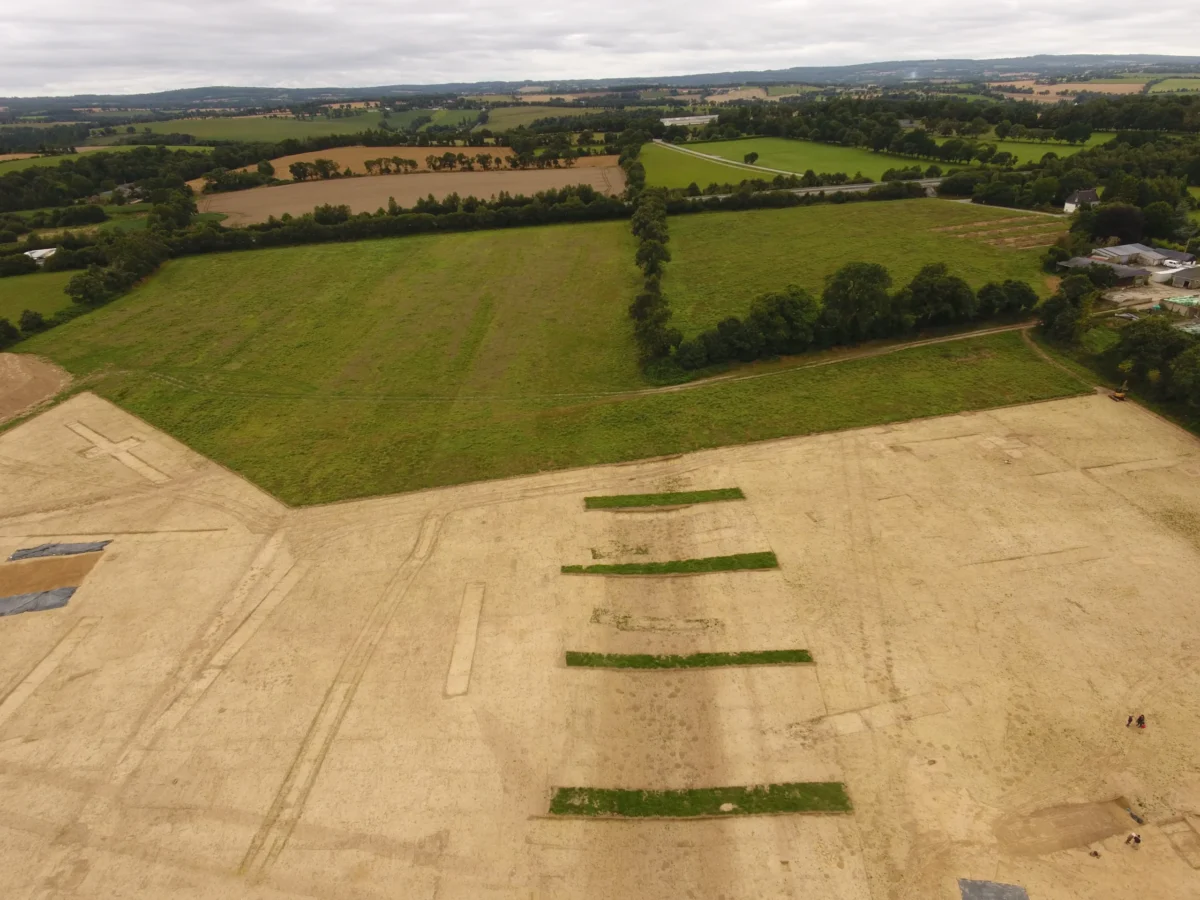 Aerial view of the Roman road connecting Vorgium to Quimperlé in the foreground. In the background, modern parcel boundaries still follow the trace of the ancient route. Credit: Florian Cousseau, Durham University