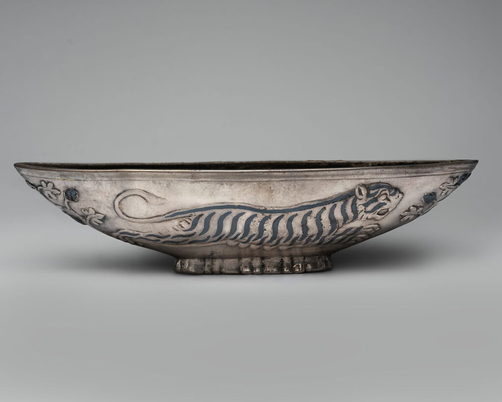 Sasanian bowl decorated with a running tiger, 6th-7th century CE. Silver, niello; 9.8 × 6.1 × 26.2 cm. Metropolitan Museum of Art, New York, 1989.281.37. Credit: Public domain image from the Metropolitan Museum of Art