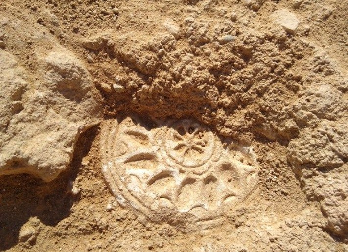 Bread-stamp emerging from Excavation Unit 20. Credit: Department of Antiquities of Cyprus via Facebook