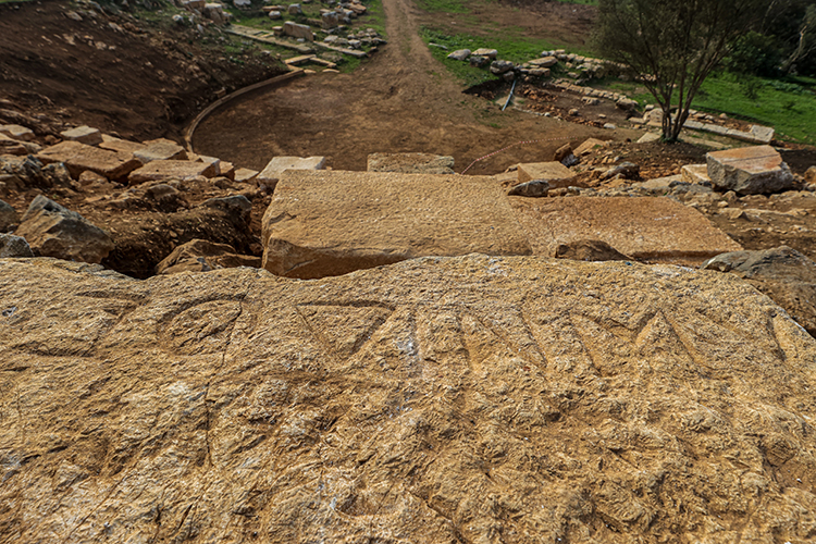 The inscription ‘Lonidos’ was discovered on one of the uppermost rows (summa cavea) of the ancient Roman theatre. Credit: Mustafa Yılmaz/AA