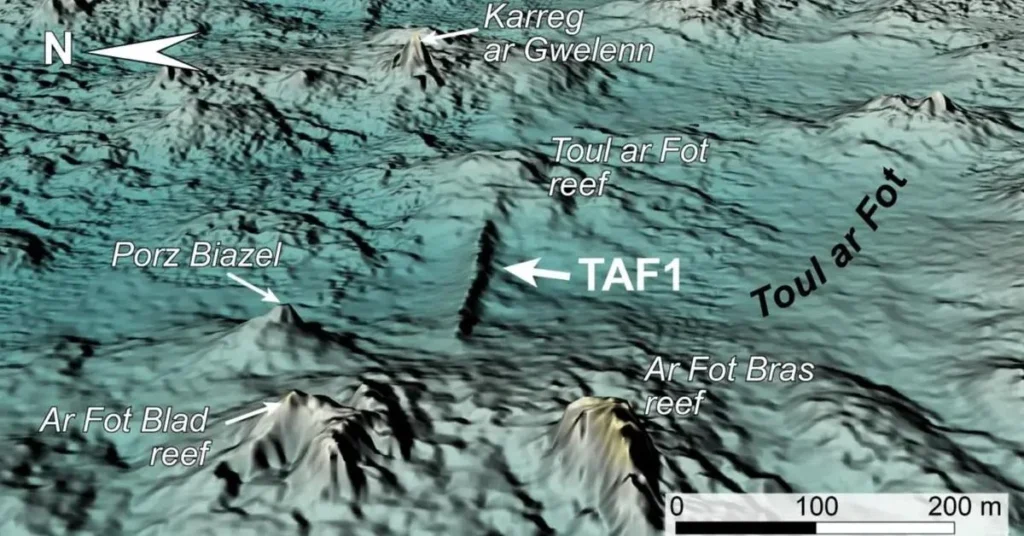 Three-dimensional view of the TAF1 structures looking east, highlighting the pronounced linearity of the construction and the asymmetrical profiles of its north (left) and south (right) flanks. Vertical exaggeration is set to 3, while brown tones indicate reefs that remain permanently above the present sea level. Credit: Yves Fouquet et al., International Journal of Nautical Archaeology (2025).