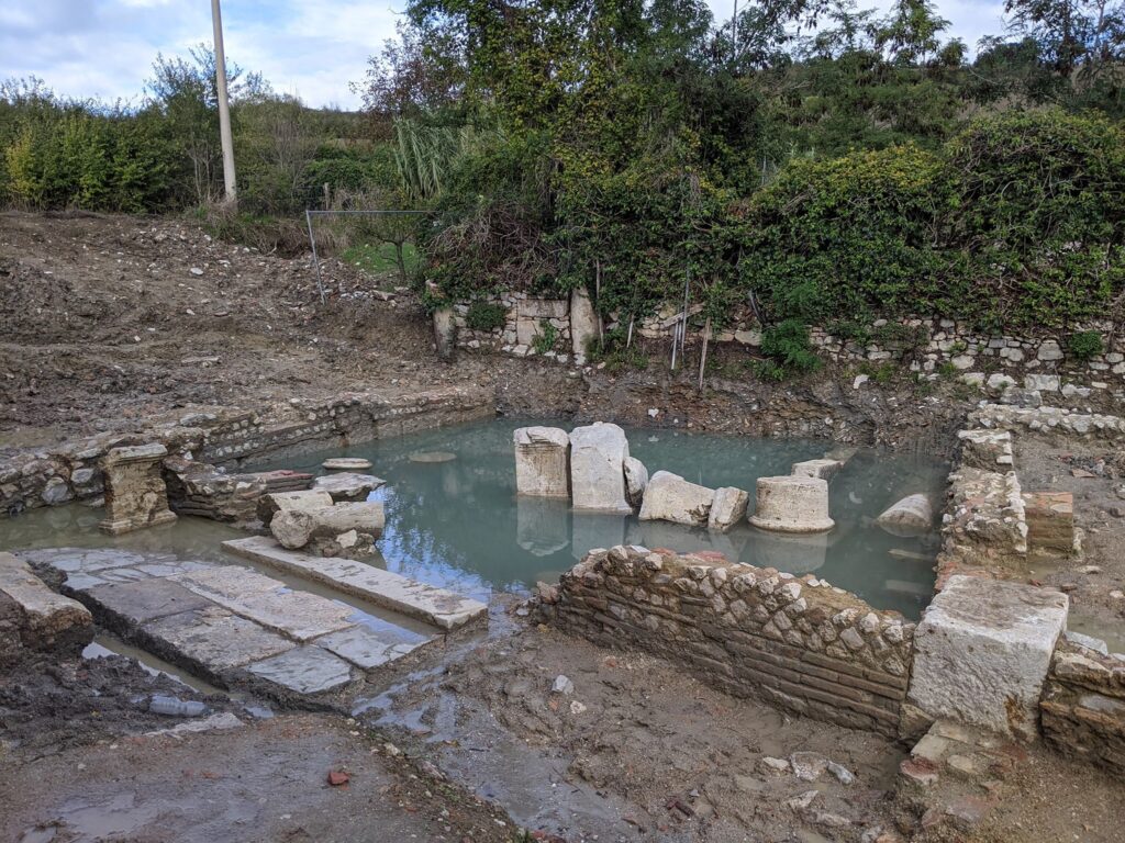 Altars were deliberately broken and rearranged into a platform constructed between the main thermal spring and a secondary spring to the south. Altars in water. Credit: Municipality of San Casciano dei Bagni